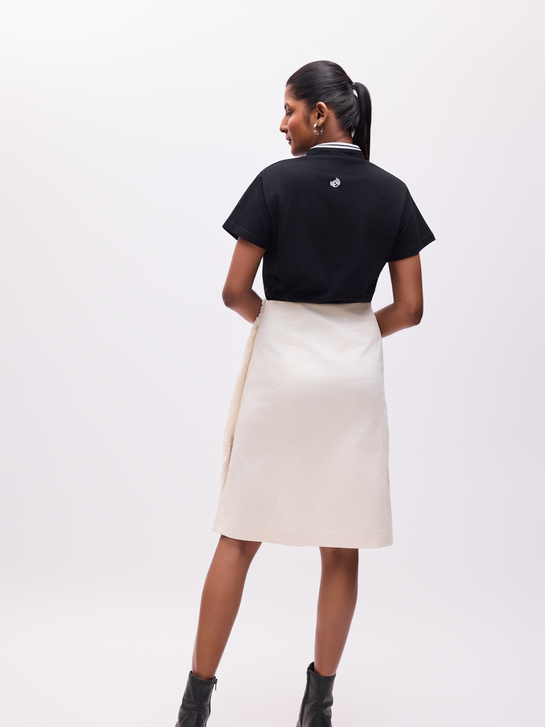 Woman wearing The Groove organic cotton black tshirt with the logo on the reverse